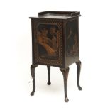 A BLACK JAPANNED BEDSIDE CUPBOARD, C1920, WITH GALLERIED SQUARE TOP AND PANELLED DOOR, DECORATED