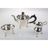 AN EDWARDIAN SILVER BACHELOR'S TEA SERVICE ON THREE HOOF FEET, TEAPOT 11.5CM H, BY MAPPIN AND WEBB