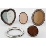 FIVE ROUND, OVAL AND HEART SHAPED SILVER PHOTOGRAPH FRAMES, EARLY 20TH C AND LATER, ONE FOREIGN,