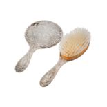 A SILVER HAND MIRROR AND HAIRBRUSH, DIE STAMPED WITH CHERUB'S HEADS, EARLY 20TH C AND LATER, MARKS