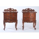 A PAIR OF REPRODUCTION MAHOGANY SERPENTINE TWO DRAWER BEDSIDE CHESTS WITH PIERCED FOLIATE