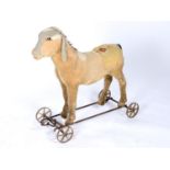 A CHILD'S PULL-ALONG DONKEY, C1900, THE STRAW STUFFED BODY COVERED IN PALE GOLD PLUSH WITH BLACK
