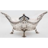 AN EDWARDIAN SAW PIERCED SILVER  DESSERT DISH OF HEAVY GAUGE, WITH ORNATE CAST SCROLLING HANDLES AND