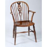 A MID 19TH C ASH AND ELM WHEEL BACK WINDSOR ELBOW CHAIR, WITH SADDLED SEAT ON TURNED LEGS JOINED