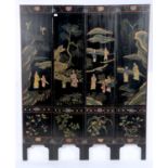 A SOUTH EAST ASIAN FOUR FOLD BLACK LACQUER SCREEN, DECORATED WITH FIGURES IN TREE FILLED