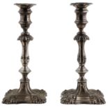 A PAIR OF GEORGE V SILVER CANDLESTICKS, IN MID 18TH C ENGLISH STYLE, ON STEPPED SHELL CORNERED FOOT,