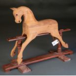 AN UNUSUAL UNPAINTED MINIATURE WOODEN ROCKING HORSE, PROBABLY A MANUFACTURER'S SAMPLE, SECOND