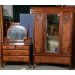 A LATE VICTORIAN WALNUT TWO PIECE BEDROOM SUITE COMPRISING WARDROBE, THE CENTRAL BEVELLED MIRROR
