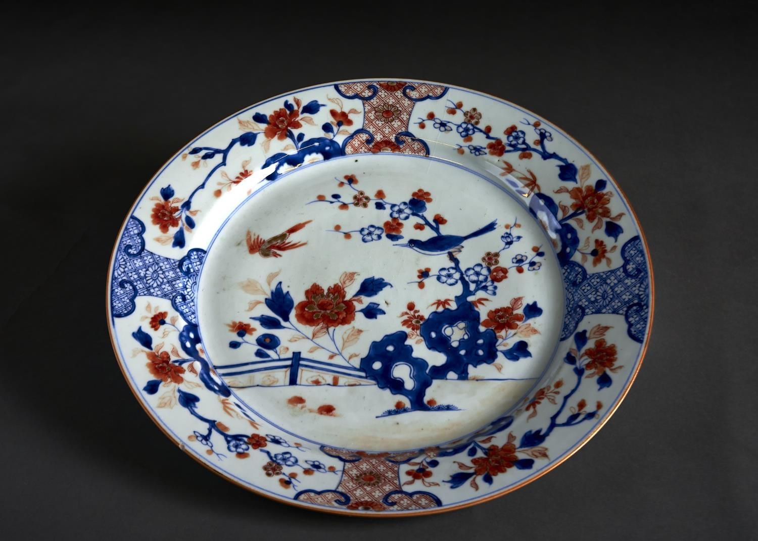A CHINESE IMARI DISH, 18TH C, PAINTED WITH BIRDS AND PEONY IN PANELLED BORDER, 38.5CM