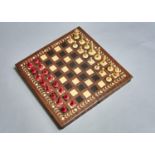 A BONE CHESS SET, 19TH C, STAINED RED AND NATURAL, KINGS 7CM H AND AN EBONY AND BONE INLAID HARDWOOD