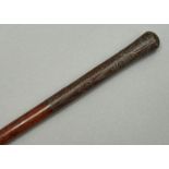 A HARDWOOD WALKING CANE, LATE 19TH / EARLY 20TH C, THE UPPER PART OF THE SHAFT AND BULBOUS POMMEL