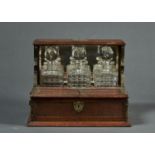 A VICTORIAN EPNS MOUNTED OAK TANTALUS, LATE 19TH C, THE TOP, LIDS AND FRONT MACHINE CARVED TO