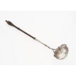 A GEORGE II SILVER PUNCH LADLE WITH FINELY TURNED MAHOGANY HANDLE, THE UNDERSIDE OF THE BOWL