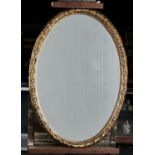 AN OVAL GILTWOOD AND COMPOSITION RIBBON AND REED MIRROR, 20TH C, 83 X 58CM Condition reportMirror