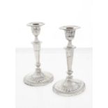 A PAIR OF VICTORIAN NEO-CLASSICAL STYLE  SILVER CANDLESTICKS, THE FLUTED SCONCE WITH REEDED BAND