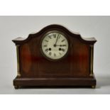 AN EDWARDIAN MAHOGANY MANTEL CLOCK OF SWEPT ARCHED FORM, INLAID WITH BOXWOOD, BARBER POLE AND
