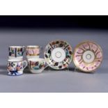 A COALPORT JAPAN PATTERN COFFEE CAN AND TRIO AND PINK AND GILT COFFEE CAN AND SAUCER, C1805-10,