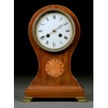 AN EDWARDIAN INLAID MAHOGANY BALLOON SHAPED CLOCK, THE WHITE ENAMEL DIAL WITH ROMAN NUMERALS AND