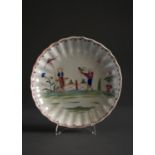 A NEW HALL FLUTED SAUCER DISH, PATTERN 20, C1783-86, ENAMELLED WITH TWO CHINESE BOYS WITH TOY OR