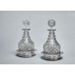 A PAIR OF VICTORIAN CUT GLASS PRUSSIAN DECANTERS AND STOPPERS, MID 19TH C, WITH THREE NECK RINGS,