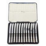 A SET OF TWELVE GEORGE V SILVER HAFTED TEA KNIVES, BY HARRISON FISHER & CO, SHEFFIELD 1931, CASED