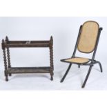 AN EBONISED BENTWOOD FOLDING CHAIR, C1920, ARCHED BACK AND LOZENGE CARVED FRAME, CANED, 90CM H;