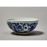 A CHINESE BLUE AND WHITE BOWL, PAINTED WITH FLOWERING PLANTS DIVIDED BY ROCKS, 15CM DIAM, CHENGHUA
