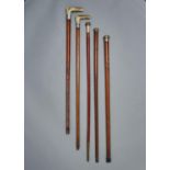 FIVE MALACCA WALKING CANES, LATE 19TH C, WITH PLATED OR OTHER METAL POMMEL OR ANTLER HANDLE, VARIOUS