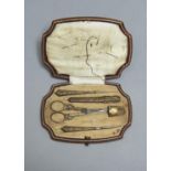 A FRENCH SILVER GILT FITTED AND GILT TOOLED BROWN LEATHER NECESSAIRE, C1910, THE NEEDLEWORK TOOLS