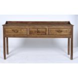 A GEORGE III PINE DRESSER BASE, C1800, WITH SHALLOW THREE QUARTER UPSTAND, THE FRONT WITH MOULDED