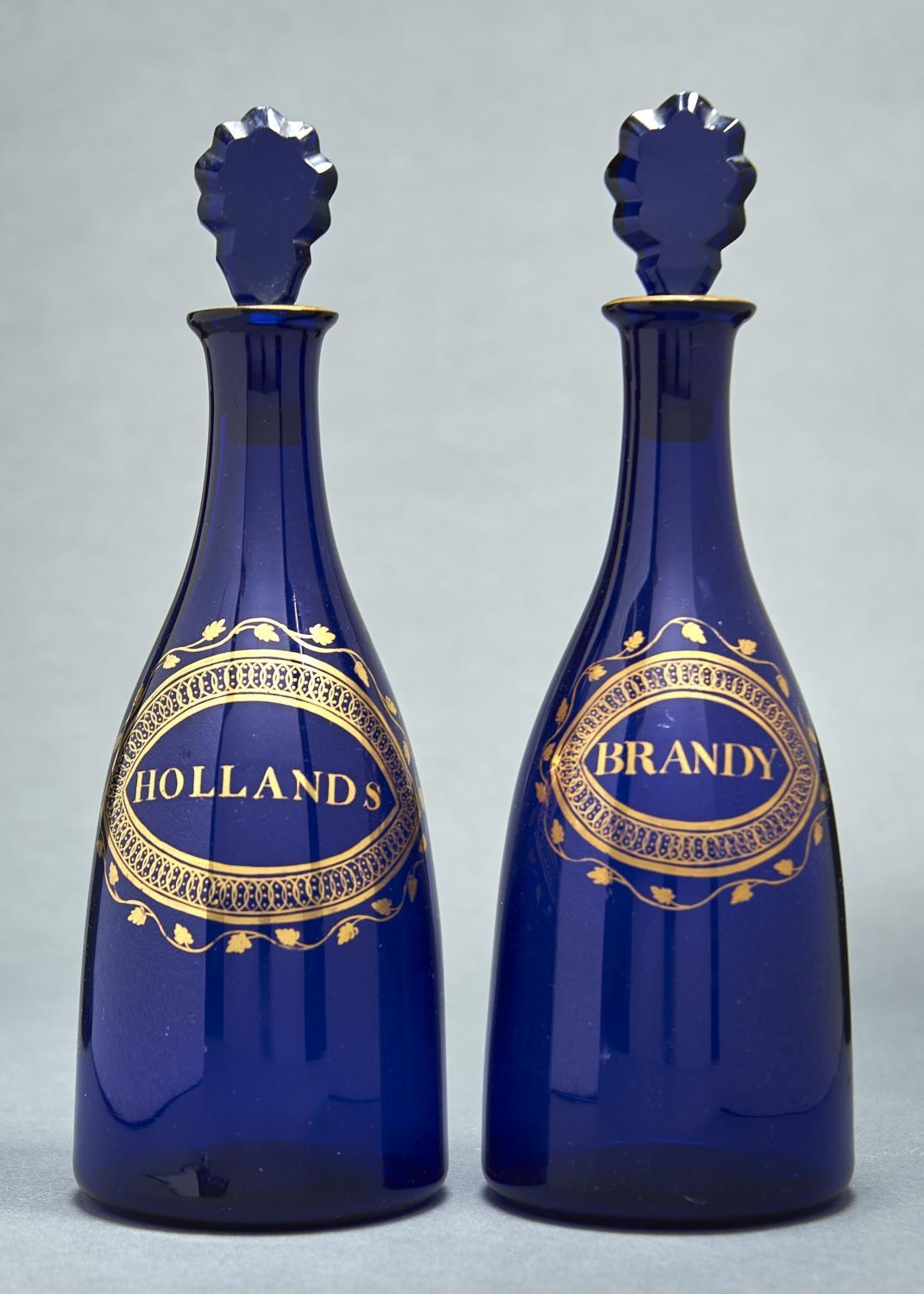 A PAIR OF ENGLISH COBALT BLUE GLASS DECANTERS AND STOPPERS, C1800, WITH NEO CLASSICAL STYLE GILT