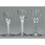 THREE ENGLISH DRINKING GLASSES, C1770, COMPRISING A FACETED STEM GLASS, THE OVOID BOWL ENGRAVED WITH