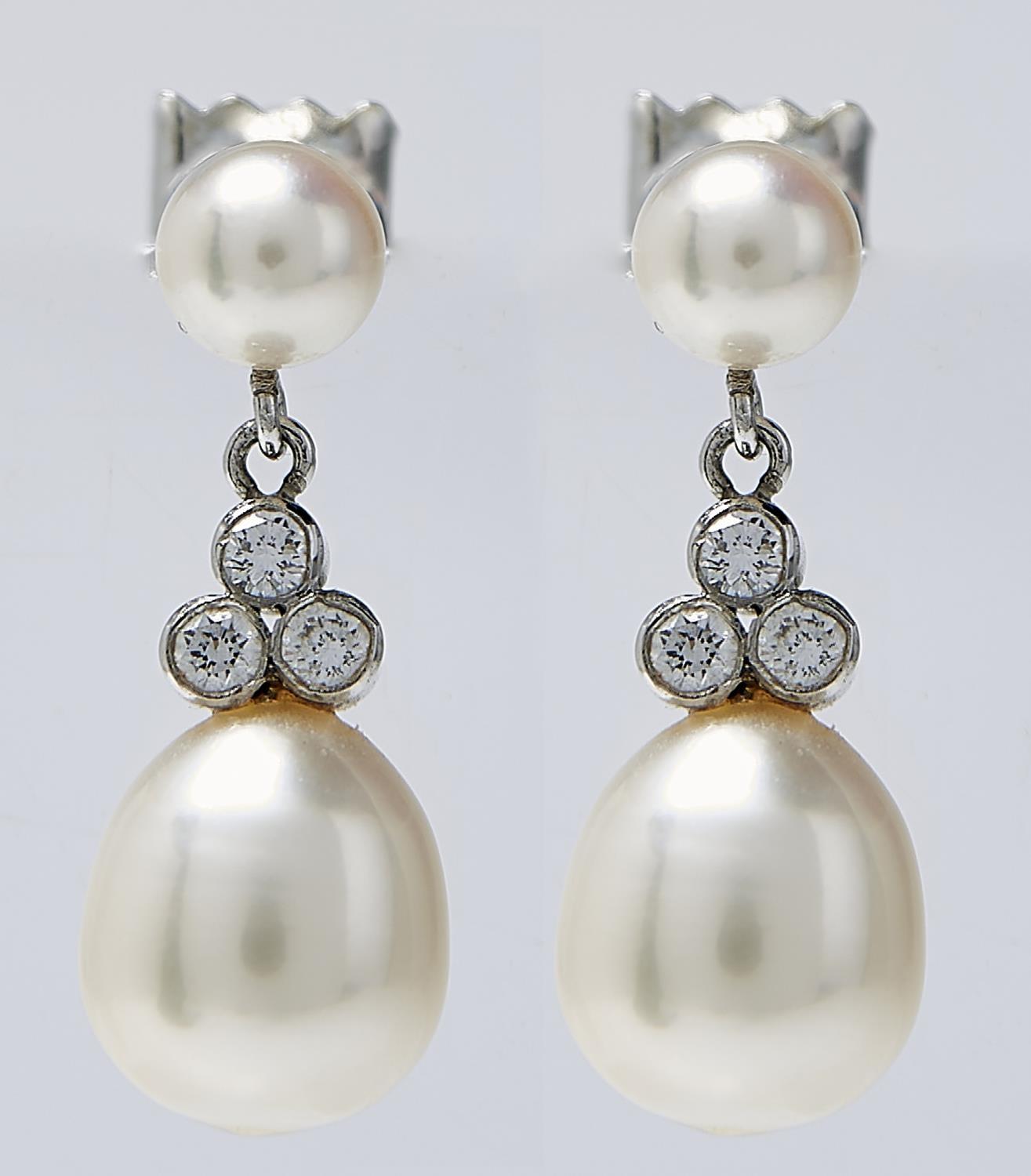 A PAIR OF CULTURED PEARL AND DIAMOND EARRINGS, THE LARGER 9MM CULTURED PEARL BENEATH A CLUSTER OF