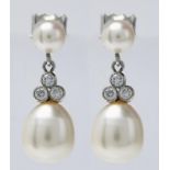 A PAIR OF CULTURED PEARL AND DIAMOND EARRINGS, THE LARGER 9MM CULTURED PEARL BENEATH A CLUSTER OF