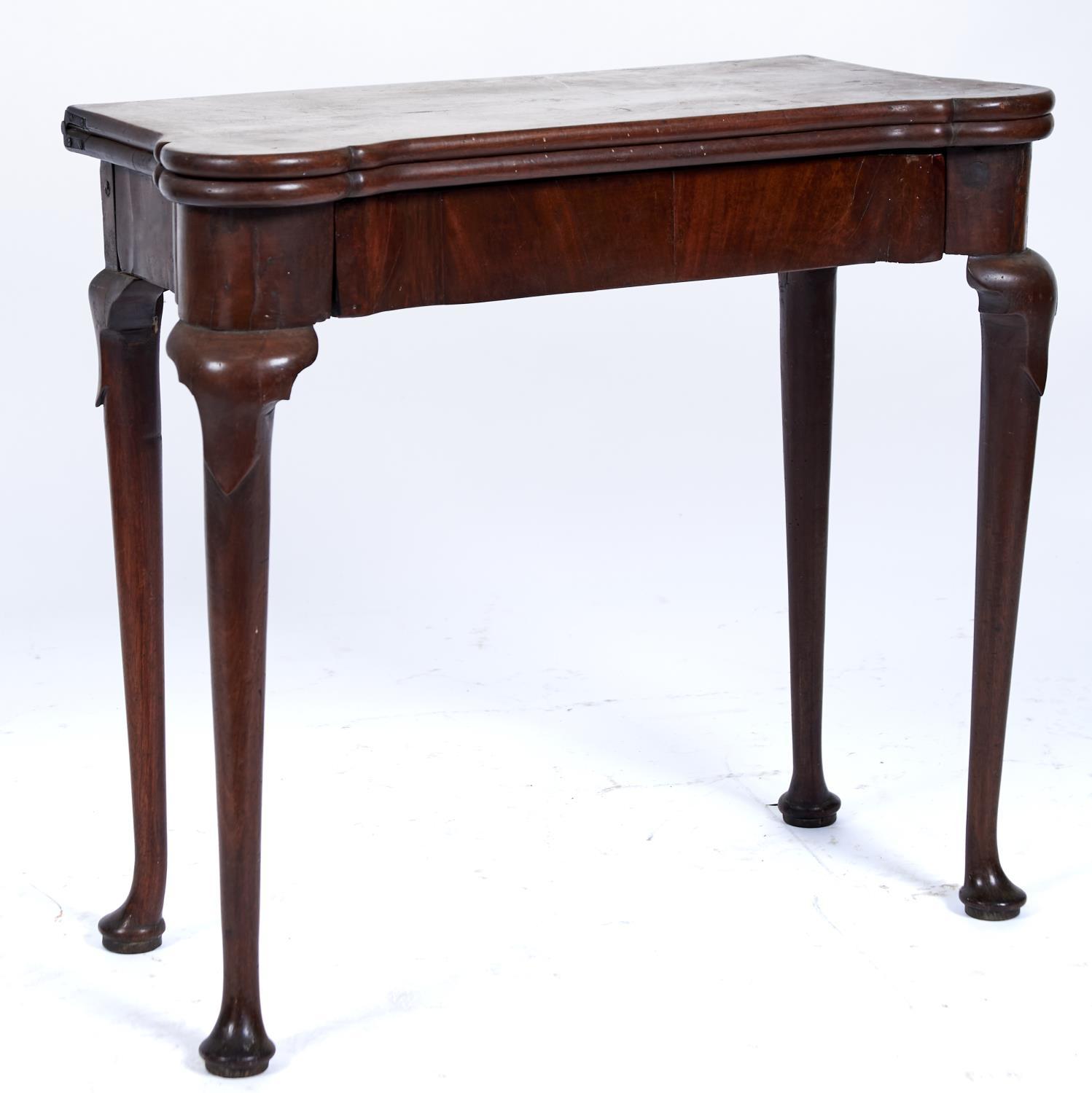 A GEORGE II MAHOGANY CARD TABLE, C1750, THE TOP WITH PAIR OF ROUNDED ANGLES REVEALING A GREEN