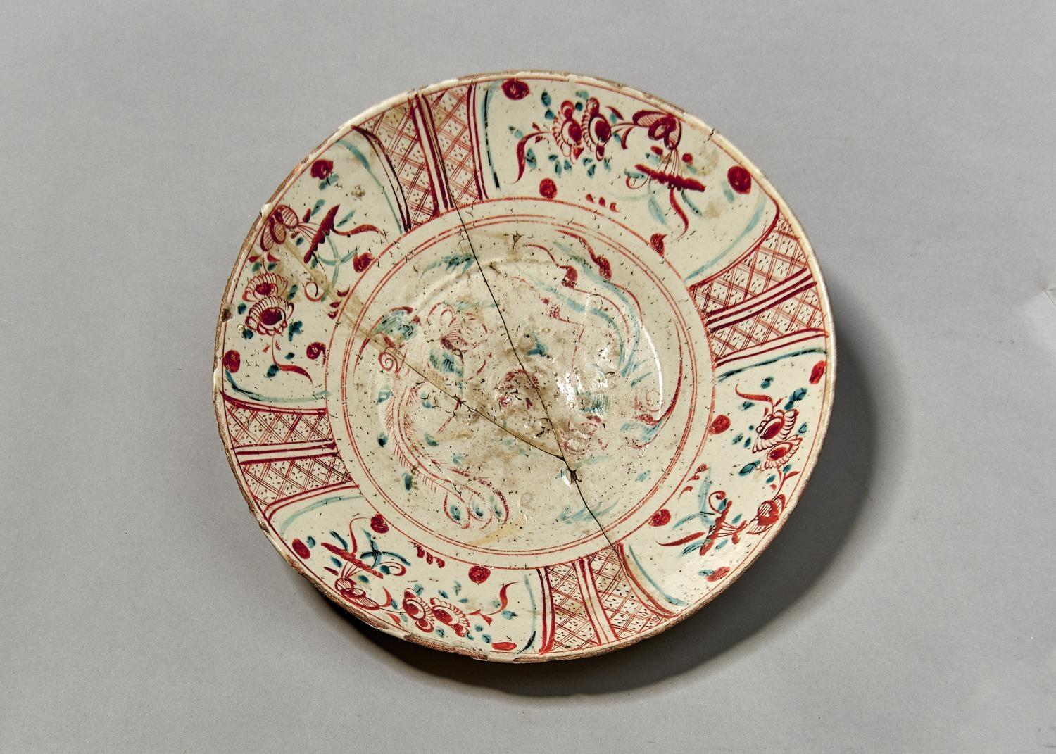 A CHINESE SWATOW WARE DISH, 17TH C, FREELY PAINTED IN RED AND GREENISH BLUE WITH PHOENIX, THE DIAPER