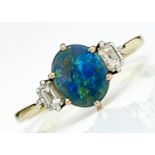 A BLACK OPAL AND DIAMOND RING. THE BLACK OPAL OF APPROX 7 X 9MM FLANKED BY BAGUETTE DAIMONDS IN 18CT