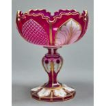 A BOHEMIAN  OVERLAY GLASS COMPORT, C1865, OF CRANBERRY CASED IN WHITE AND GILT, THE COMPRESSED