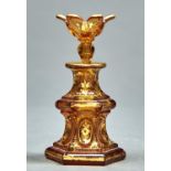 AN AMBER STAINED GLASS SCENT BOTTLE AND STOPPER, MID 19TH C, OF WAISTED HEXAGONAL FORM AND GILT WITH