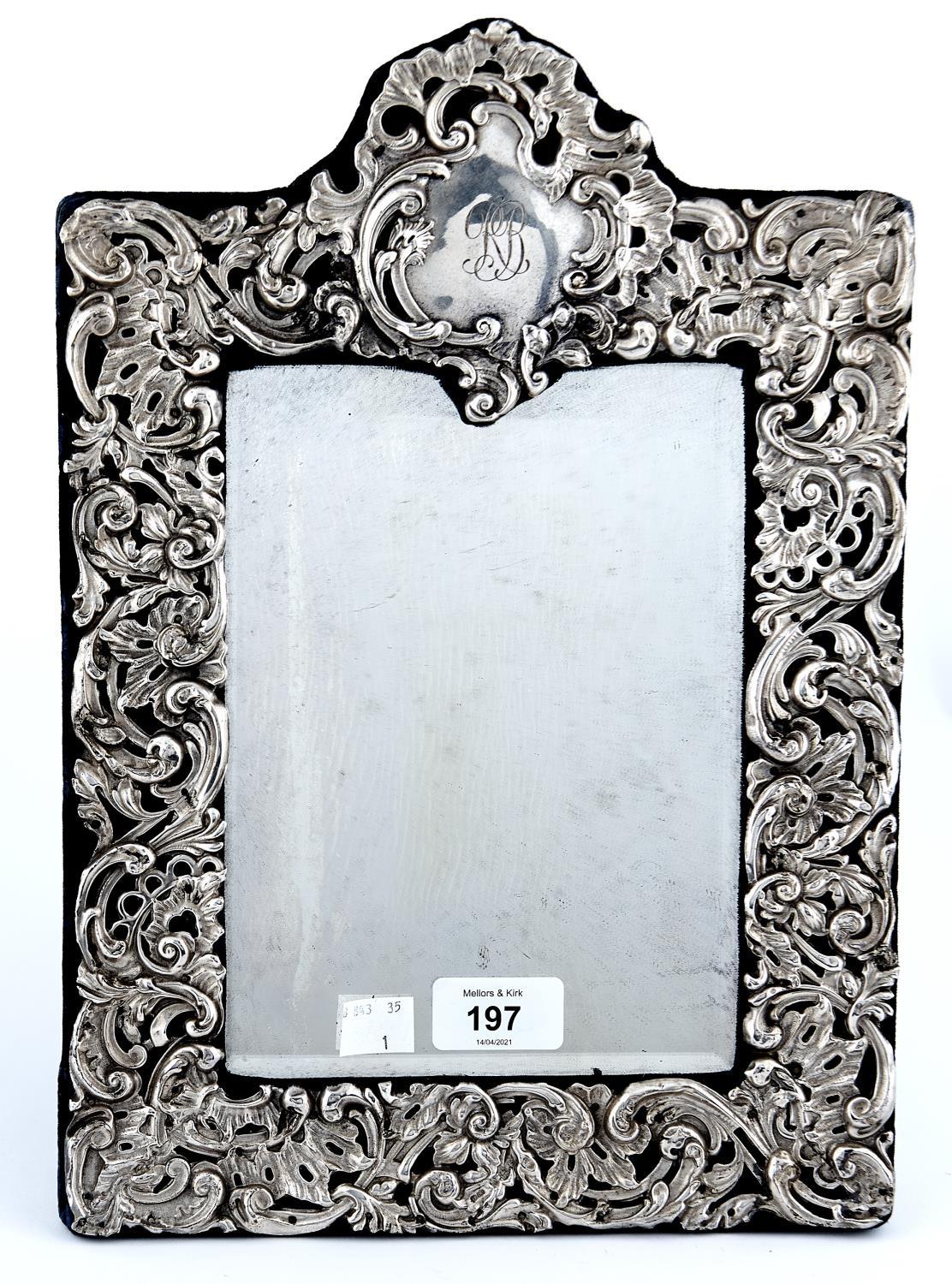 A GEORGE V SILVER DRESSING MIRROR, THE BEVELLED PLATE IN DIE STAMPED OPENWORK ROCOCO MOUNT WITH