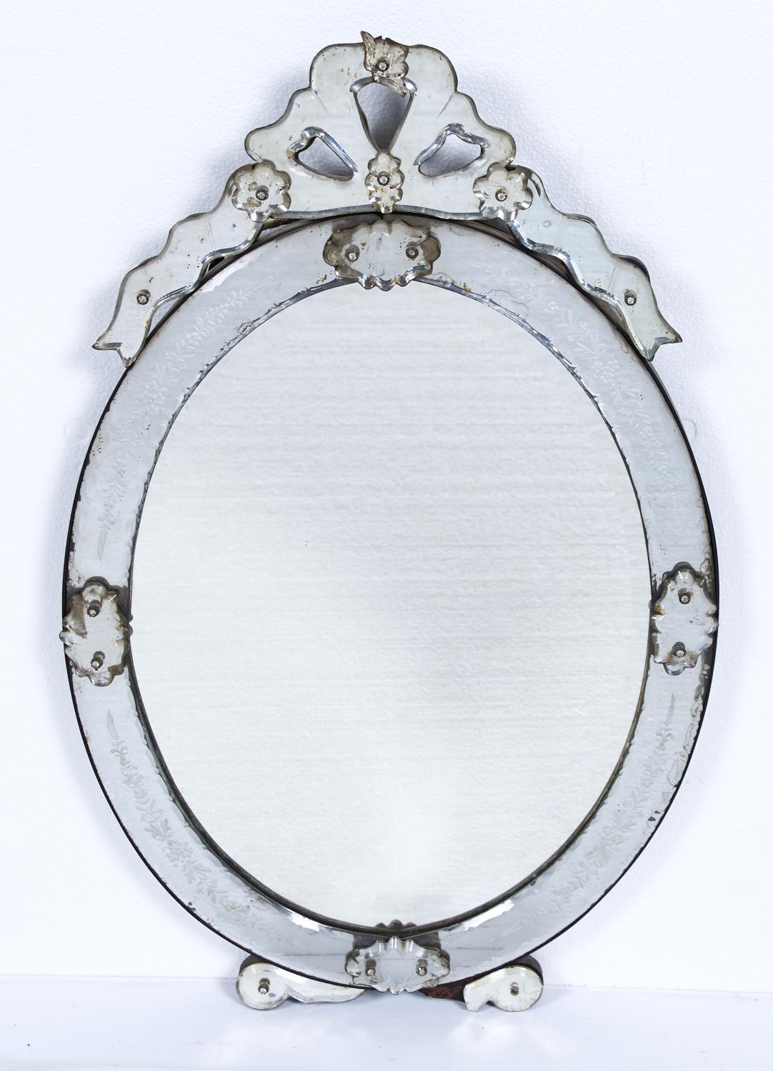 A VENETIAN OVAL MIRROR, LATE 19TH C, WITH PIERCED CRESTING AND GLASS FLOWERHEAD BOSSES, THE BEVELLED