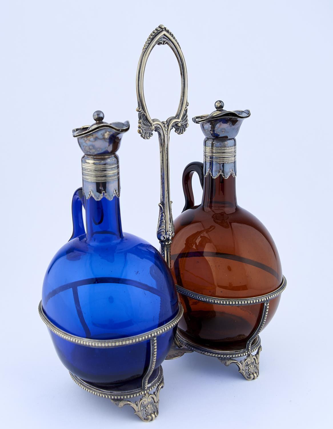 A VICTORIAN EPNS DECANTER FRAME AND PAIR OF CONTEMPORARY COLOURED GLASS, BOCKSBUTEL, C1870, 33CM H