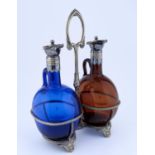 A VICTORIAN EPNS DECANTER FRAME AND PAIR OF CONTEMPORARY COLOURED GLASS, BOCKSBUTEL, C1870, 33CM H