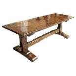 A REPRODUCTION OAK REFECTORY TABLE IN MID 17TH C STYLE, THE CLEATED PLANK TOP ABOVE CHAMFERED SQUARE