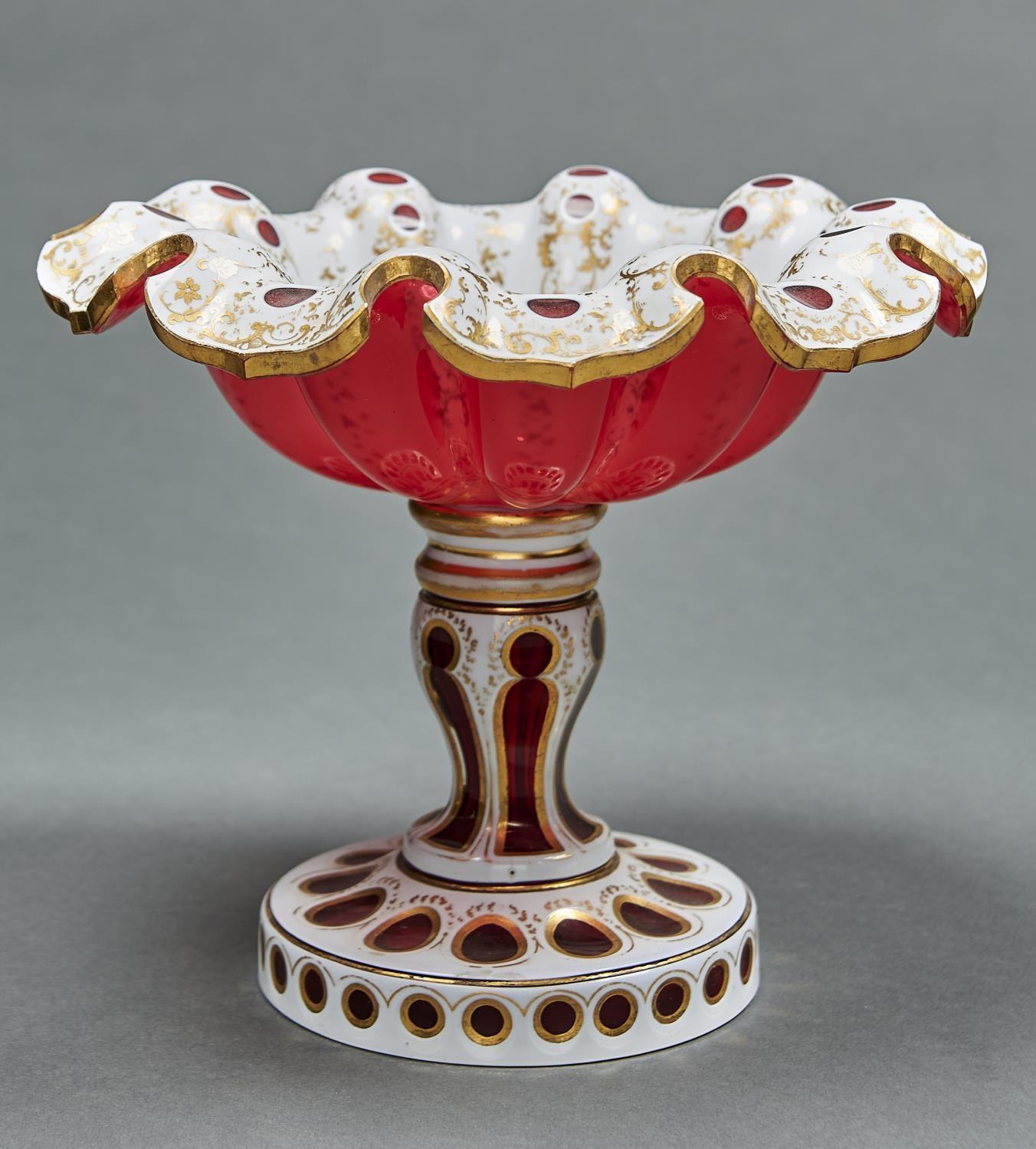 A CASED GLASS COMPORT, C1865, IN RUBY CASED IN WHITE AND GILT, THE DEEPLY LOBED BOWL WITH WAVY