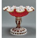A CASED GLASS COMPORT, C1865, IN RUBY CASED IN WHITE AND GILT, THE DEEPLY LOBED BOWL WITH WAVY
