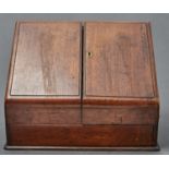 AN EDWARDIAN SLOPE FRONTED OAK STATIONERY CABINET, C1910, WITH FITTED INTERIOR AND PAIR OF DOORS,