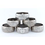 A PART SET OF SIX VICTORIAN SILVER NAPKIN RINGS, FOLIATE ENGRAVED, INITIALLED R AND NUMBERED, BY