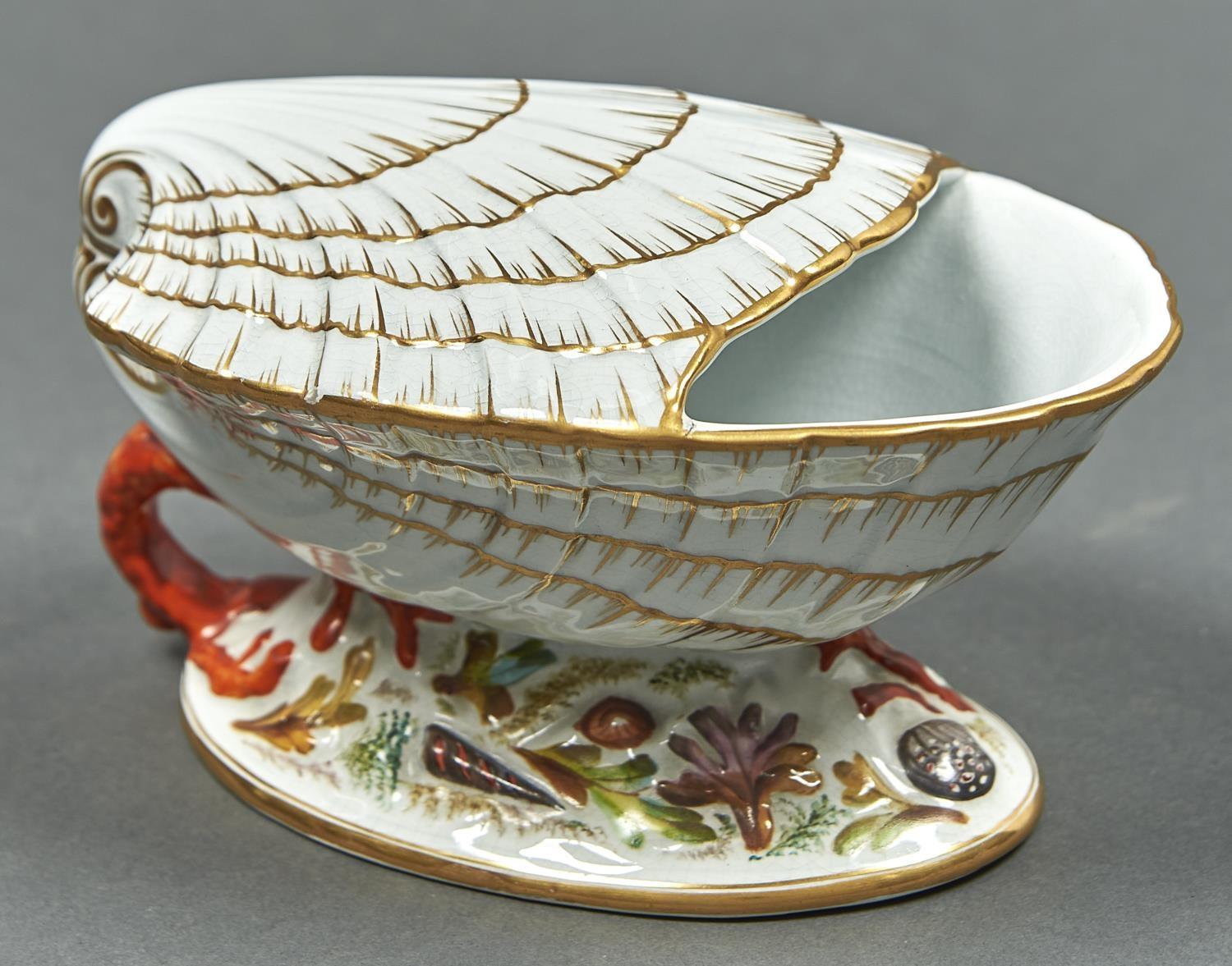 A VICTORIAN STAFFORDSHIRE SHELL SHAPED SPOON WARMER ON  OVAL BASE MOULDED AND DECORATED WITH