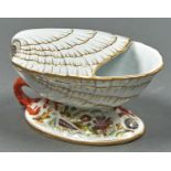 A VICTORIAN STAFFORDSHIRE SHELL SHAPED SPOON WARMER ON  OVAL BASE MOULDED AND DECORATED WITH